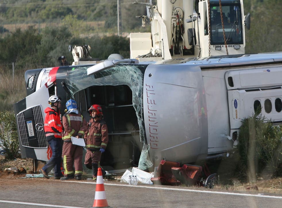 Emergency services' members work at the site of a coach crash that has left at least 14 students died at the AP-7 motorway in Freginals, in the province of Tarragona, northeastern Spain, 20 March 2016