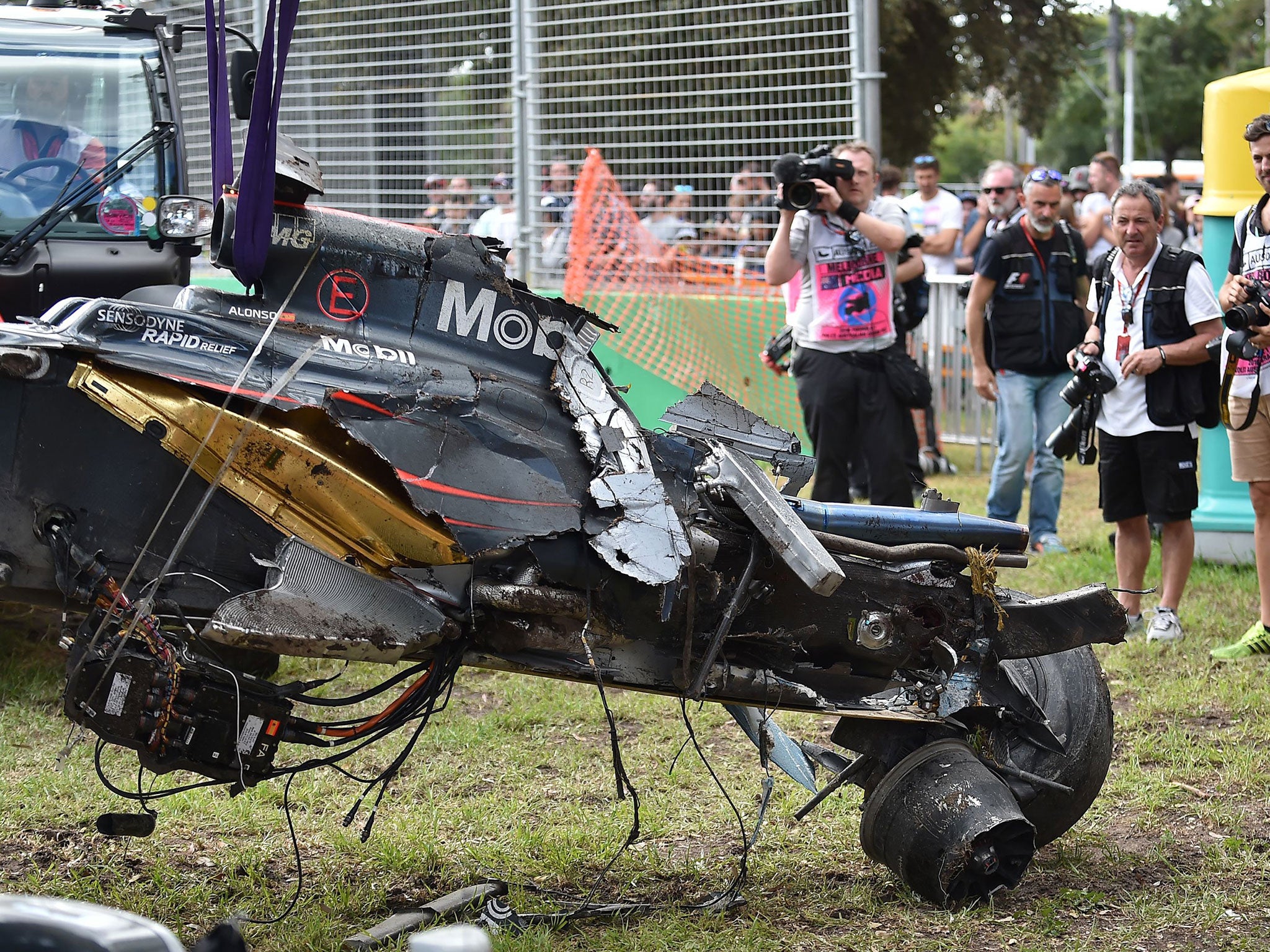 Fernando Alonso's McLaren is lifted from the Albert Park circuit