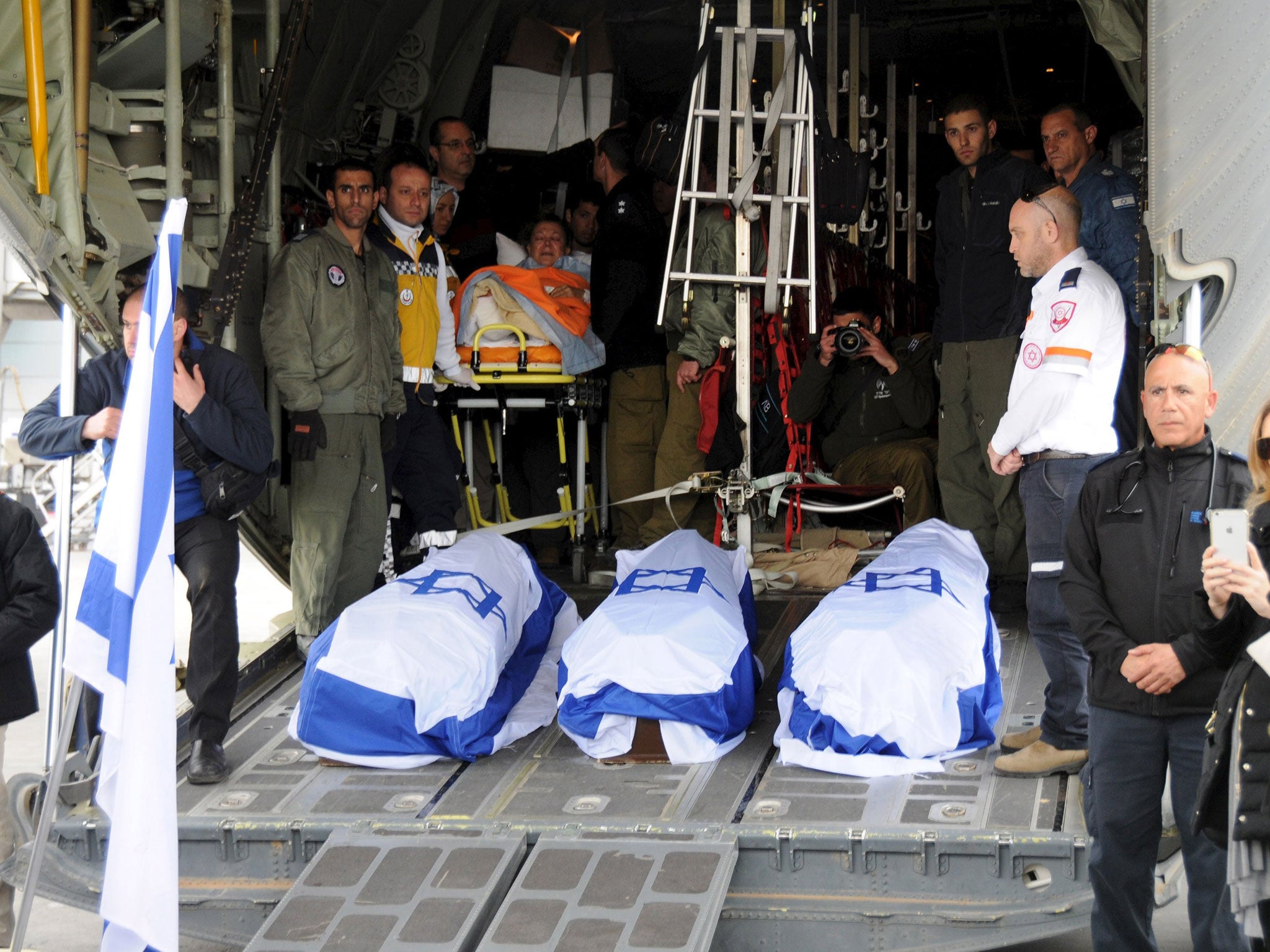 The flag-draped coffins of the victims of Saturday's suicide bombing, are loaded on a military aircraft at Ataturk International airport in Istanbul, Turkey March 20, 2016