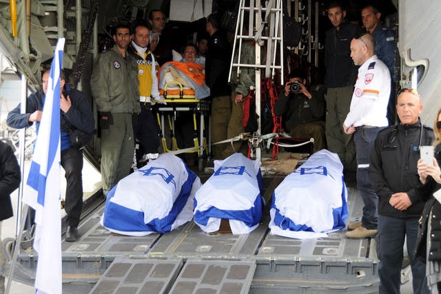 The flag-draped coffins of the victims of Saturday's suicide bombing, are loaded on a military aircraft at Ataturk International airport in Istanbul, Turkey March 20, 2016