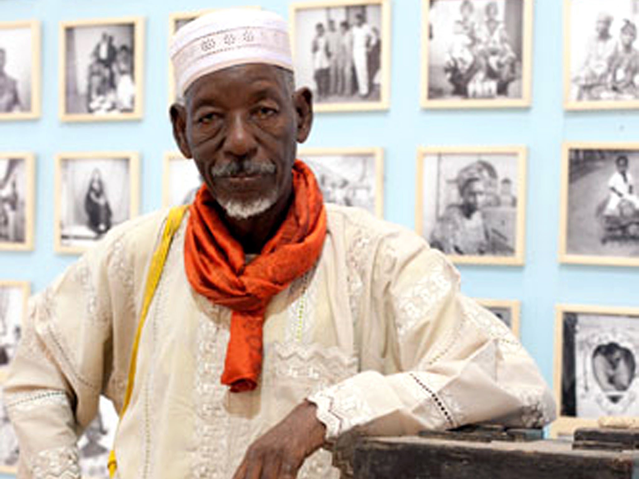 Ly with one of his first cameras and some of his work, at a festival in Dakar in 2010.
