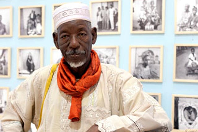 Ly with one of his first cameras and some of his work, at a festival in Dakar in 2010.