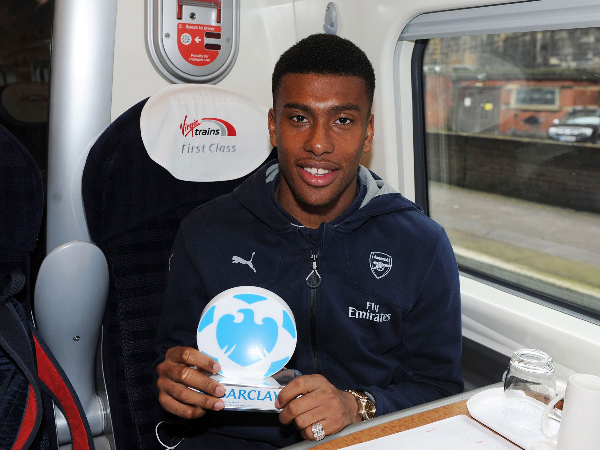 Alex Iwobi with his Man Of The Match award on the train back to London after the Barclays Premier League match between Everton and Arsenal at Goodison Park