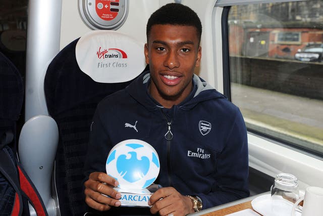 Alex Iwobi with his Man Of The Match award on the train back to London after the Barclays Premier League match between Everton and Arsenal at Goodison Park