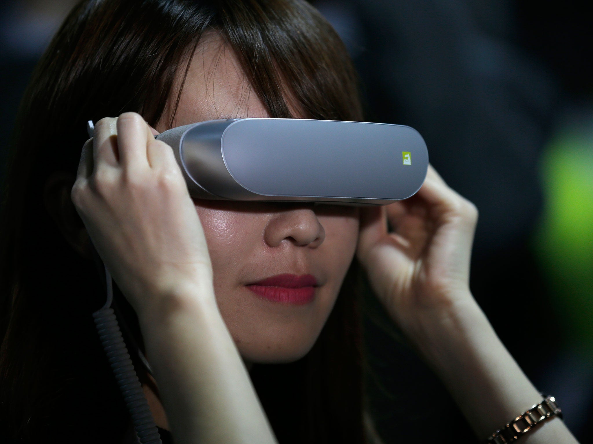A woman experiments with LG 360 VR glasses at the World Mobile Congress. VR is set to become a billion-dollar business in 2016