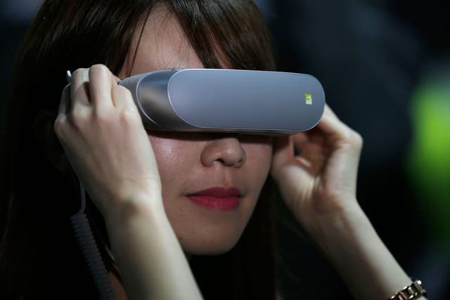 A woman experiments with LG 360 VR glasses at the World Mobile Congress. VR is set to become a billion-dollar business in 2016