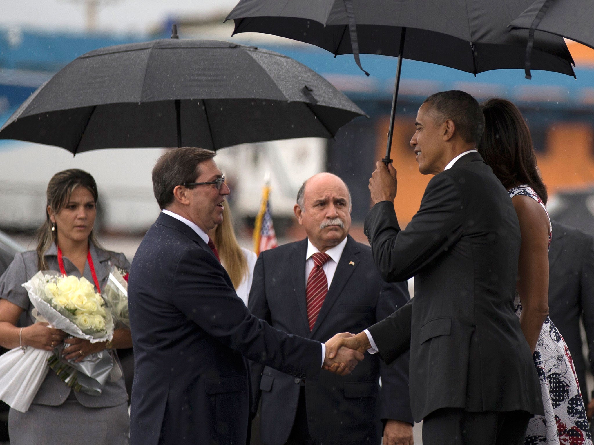 President Barack Obama shakes hands with Cuba's Foreign Minister Bruno Rodriguez upon arrival to the airport in Havana, Cuba