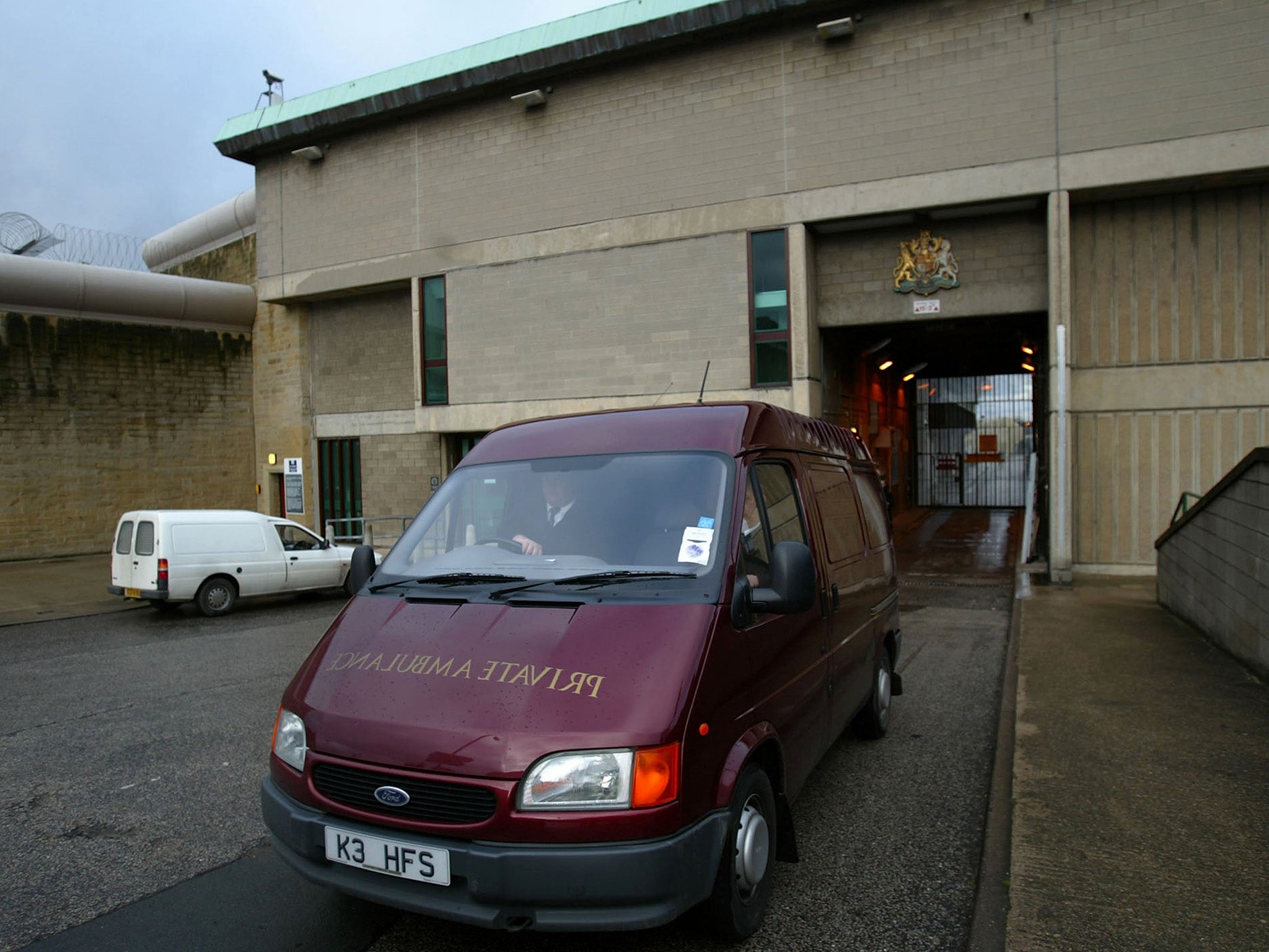 A funeral director leaving Wakefield prison where Shipman was found dead in 2004