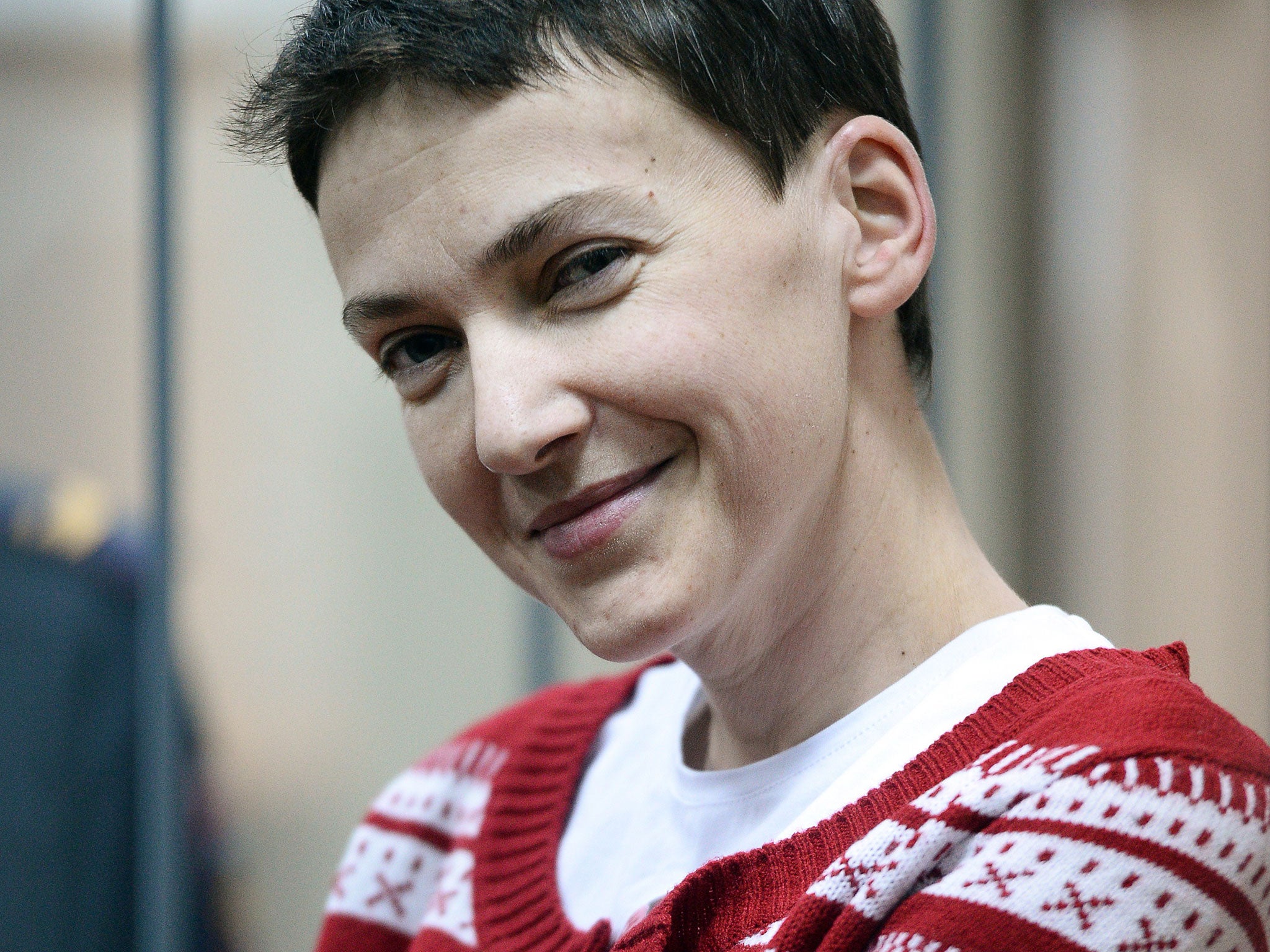 Ukrainian airforce officer Nadezhda (Nadia) Savchenko smiles inside a defendants' cage as she attends a hearing at the Basmanny district court in Moscow on March 4, 2015