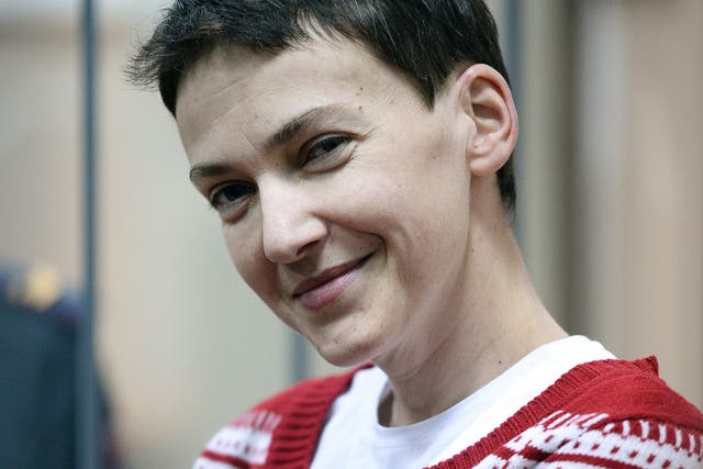 Ukrainian airforce officer Nadezhda (Nadia) Savchenko smiles inside a defendants' cage as she attends a hearing at the Basmanny district court in Moscow on March 4, 2015