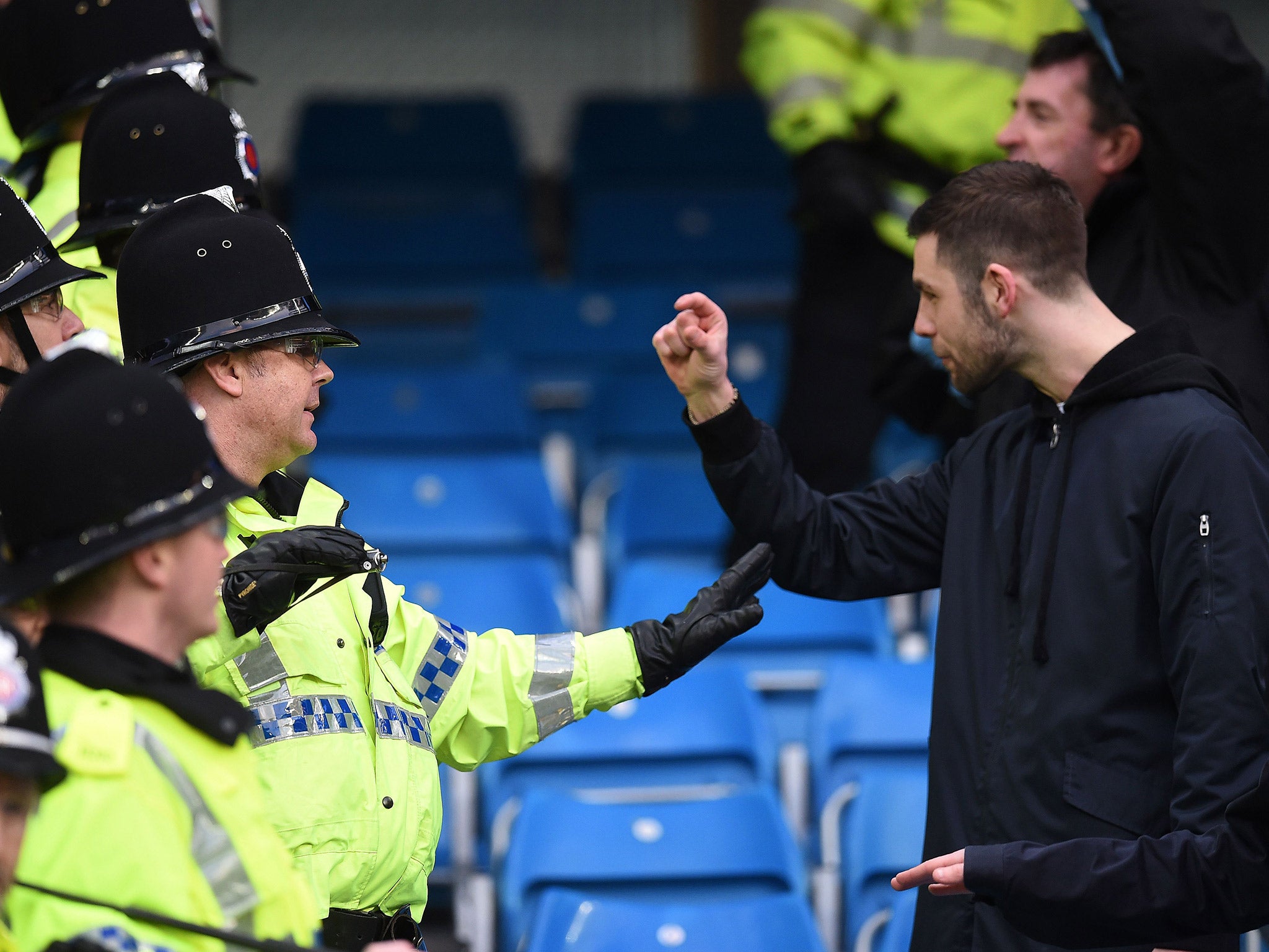 
Another fan appears to complain to police during the clashes 