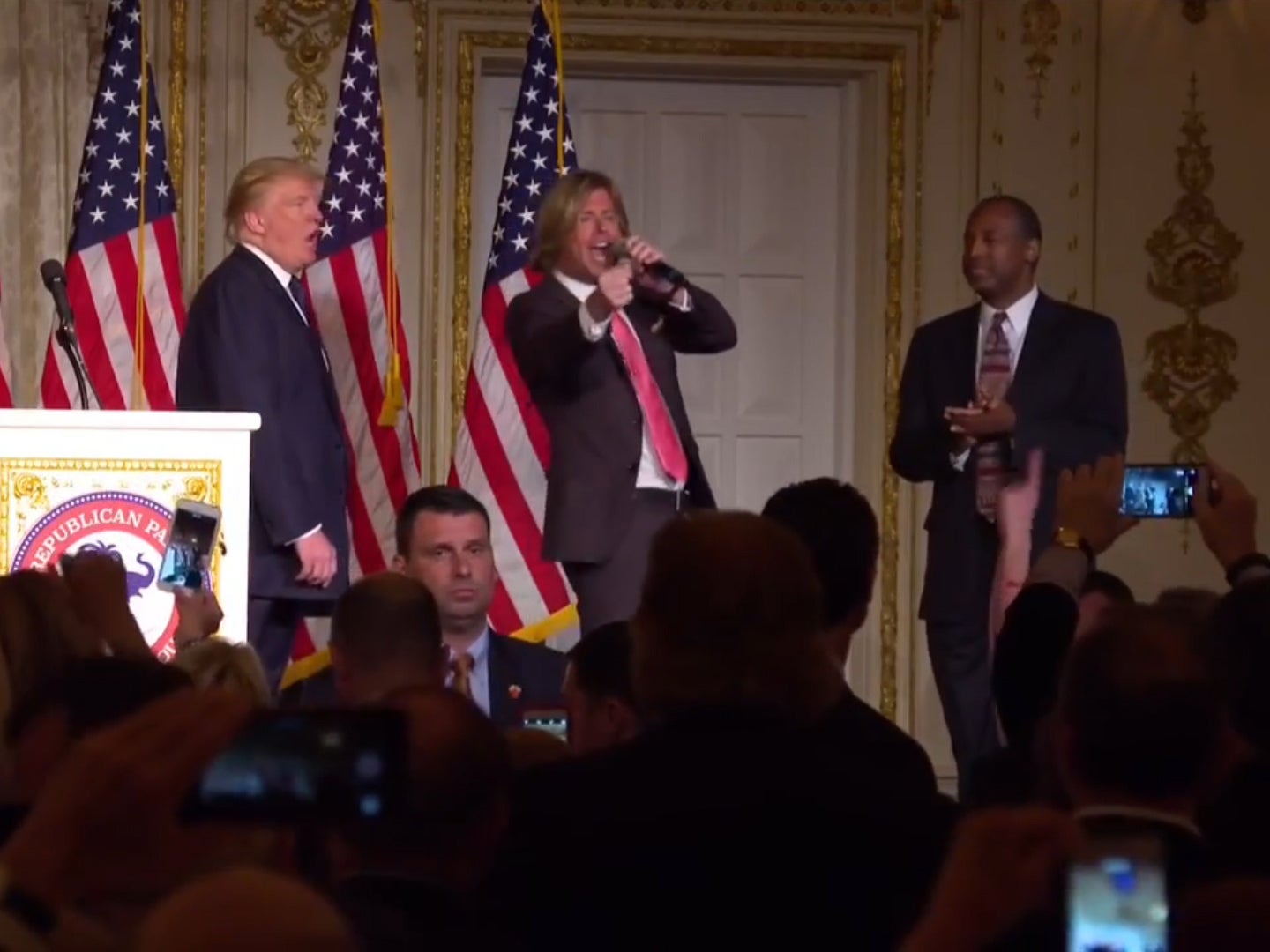 Donald Trump and Ben Carson dance awkwardly on stage together as singer serenades them with 'Stand By Me'