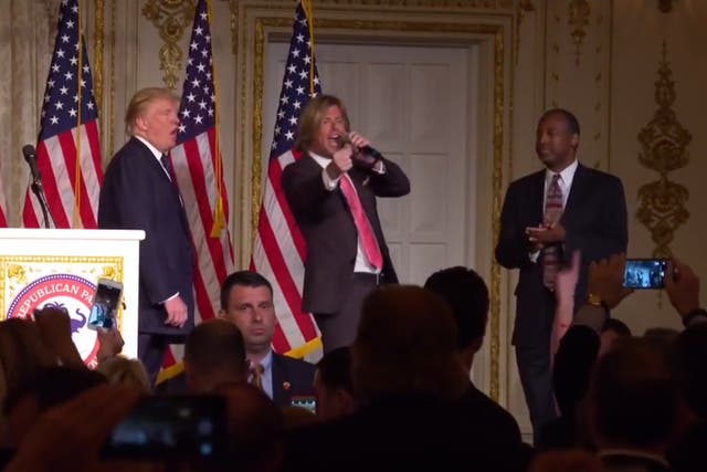 Donald Trump and Ben Carson dance awkwardly on stage together as singer serenades them with 'Stand By Me'