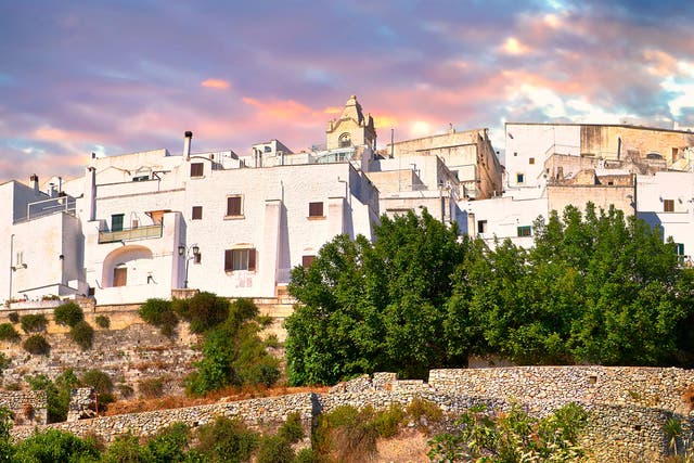 The medieval white fortified hill town walls of Ostuni, The White Town, Puglia, Italy.