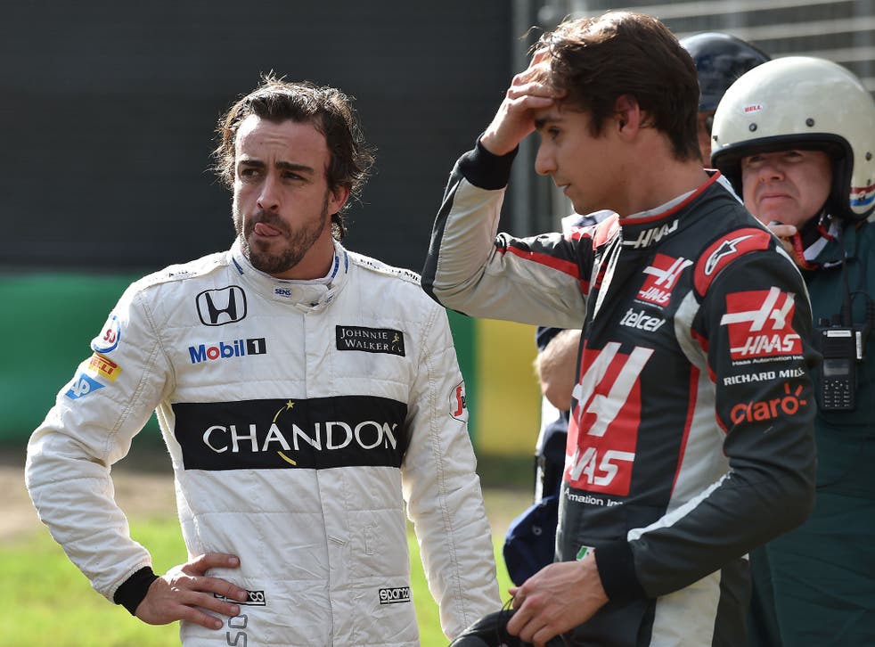 Fernando Alonso and Esteban Gutierrez talk after their crash at the Australian Grand Prix