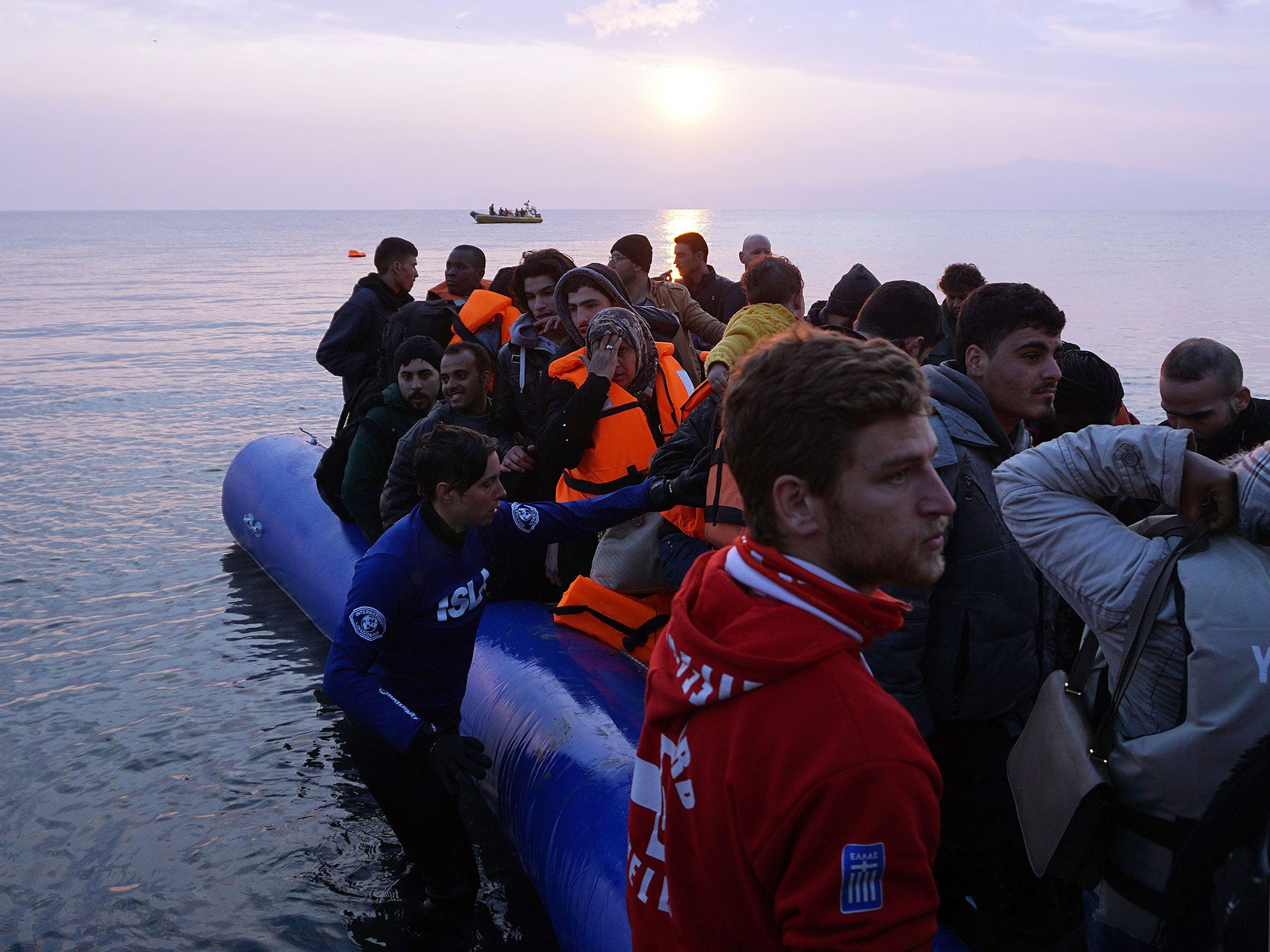 Refugees and migrants arrive on the Greek island of Lesbos on Monday