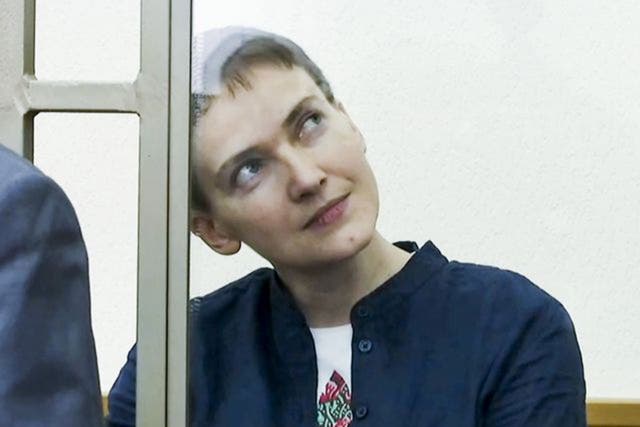 Nadezhda Savchenko sits in a glass cage in court in Donetsk