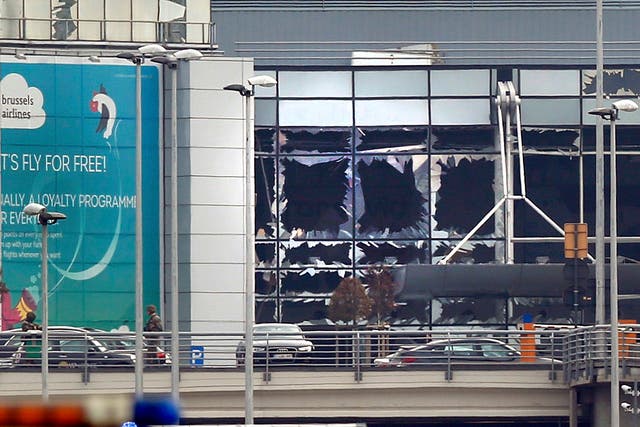 <p>Broken windows seen at the scene of explosions at Zaventem airport near Brussels in 2016 </p>