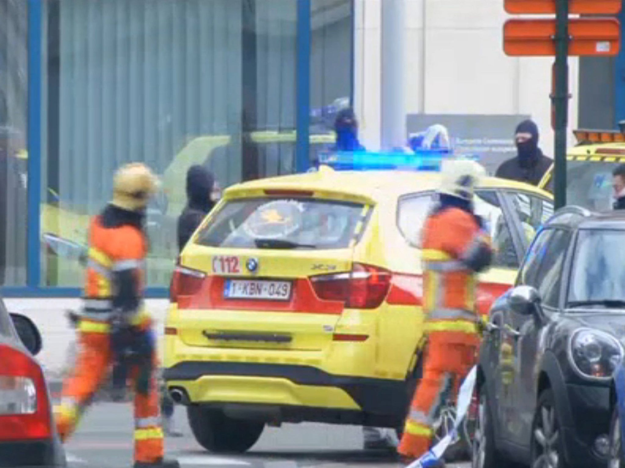 Emergency personnel are seen at the scene of a blast outside a metro station in Brussels