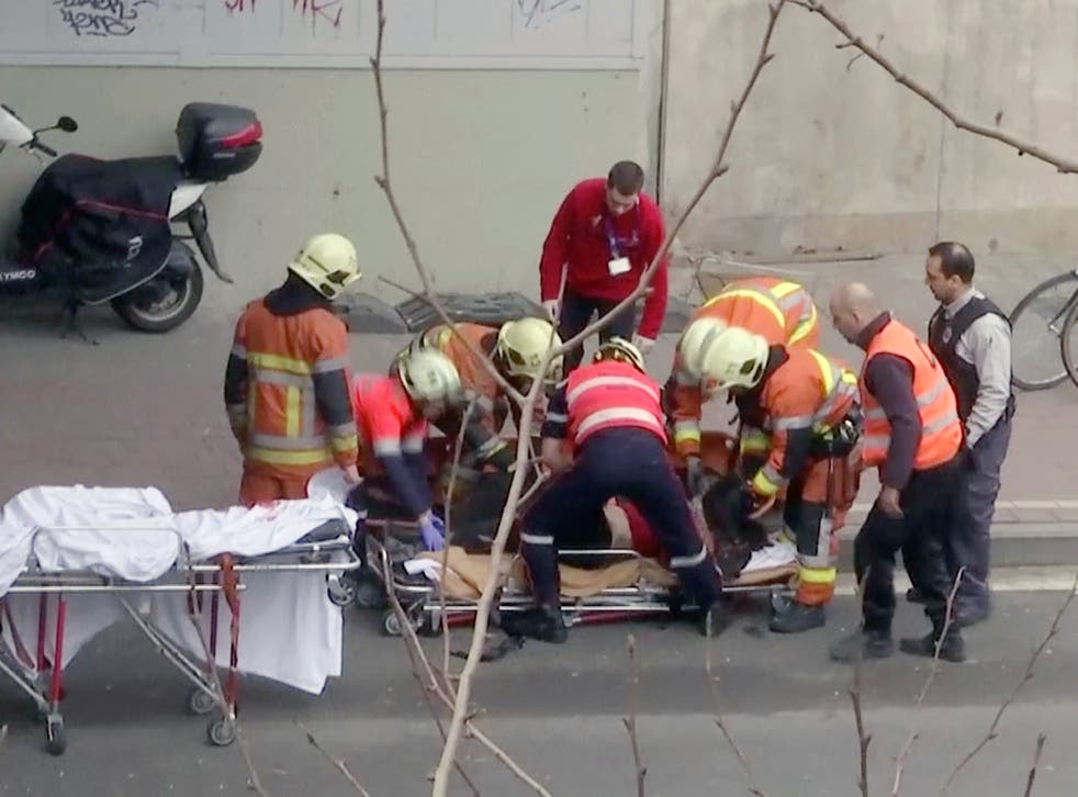 Emergency rescue workers stretcher an unidentified person at the site of an explosion at a metro station in Brussels