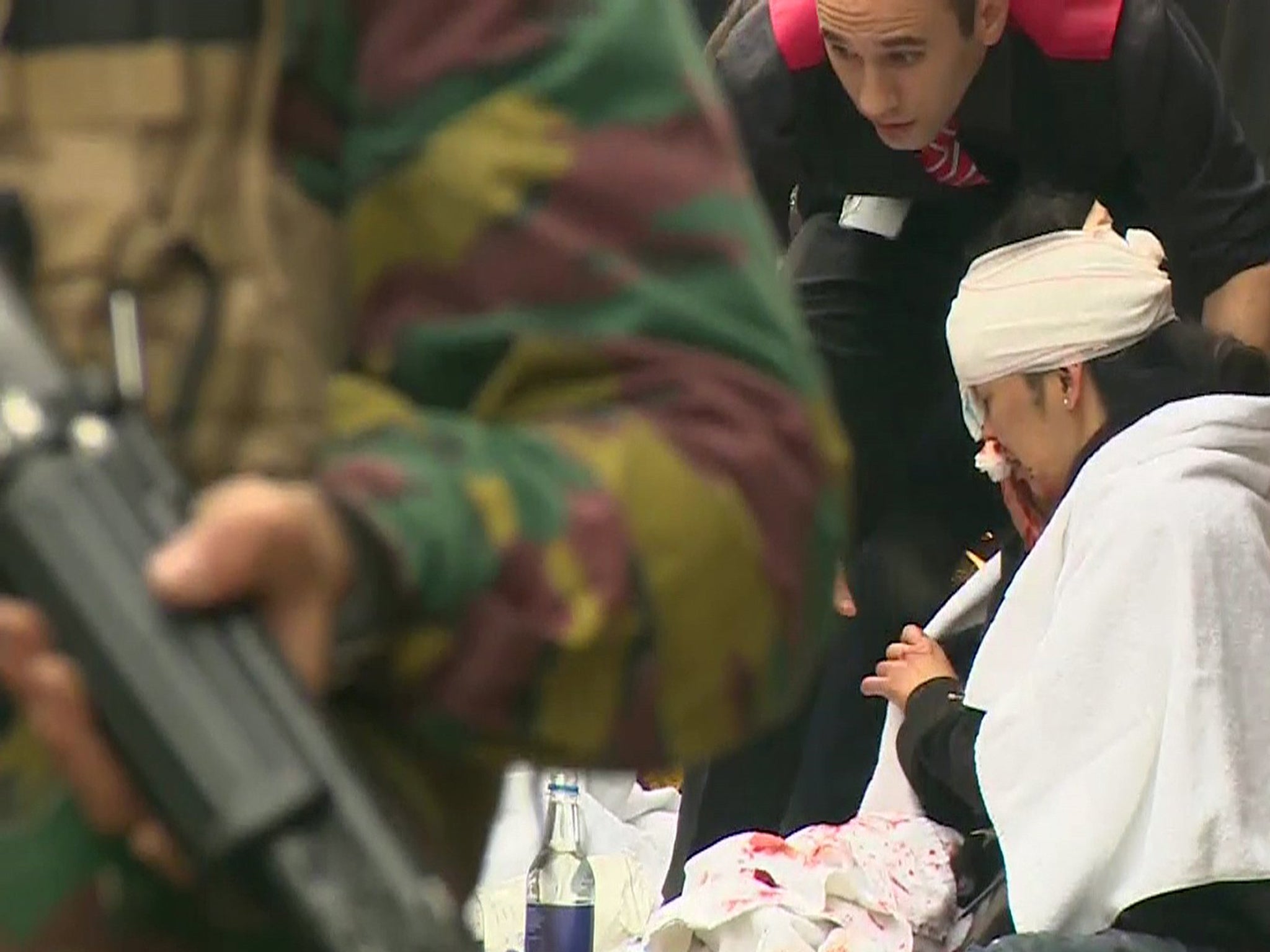 Rescue workers treat victims outside the Maelbeek underground station