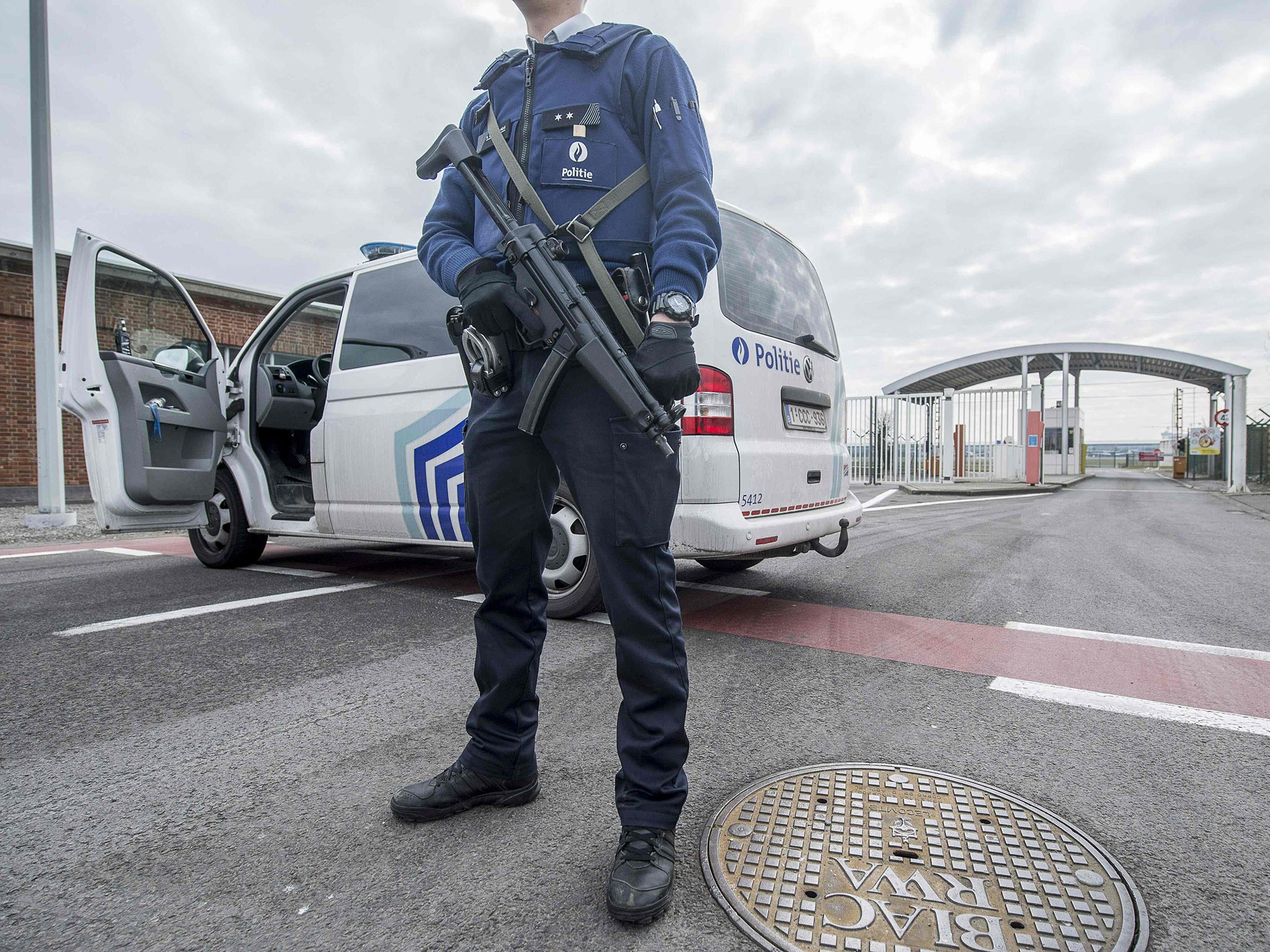 A police officer stands guard at the entrance of Brussels Airport, in Zaventem