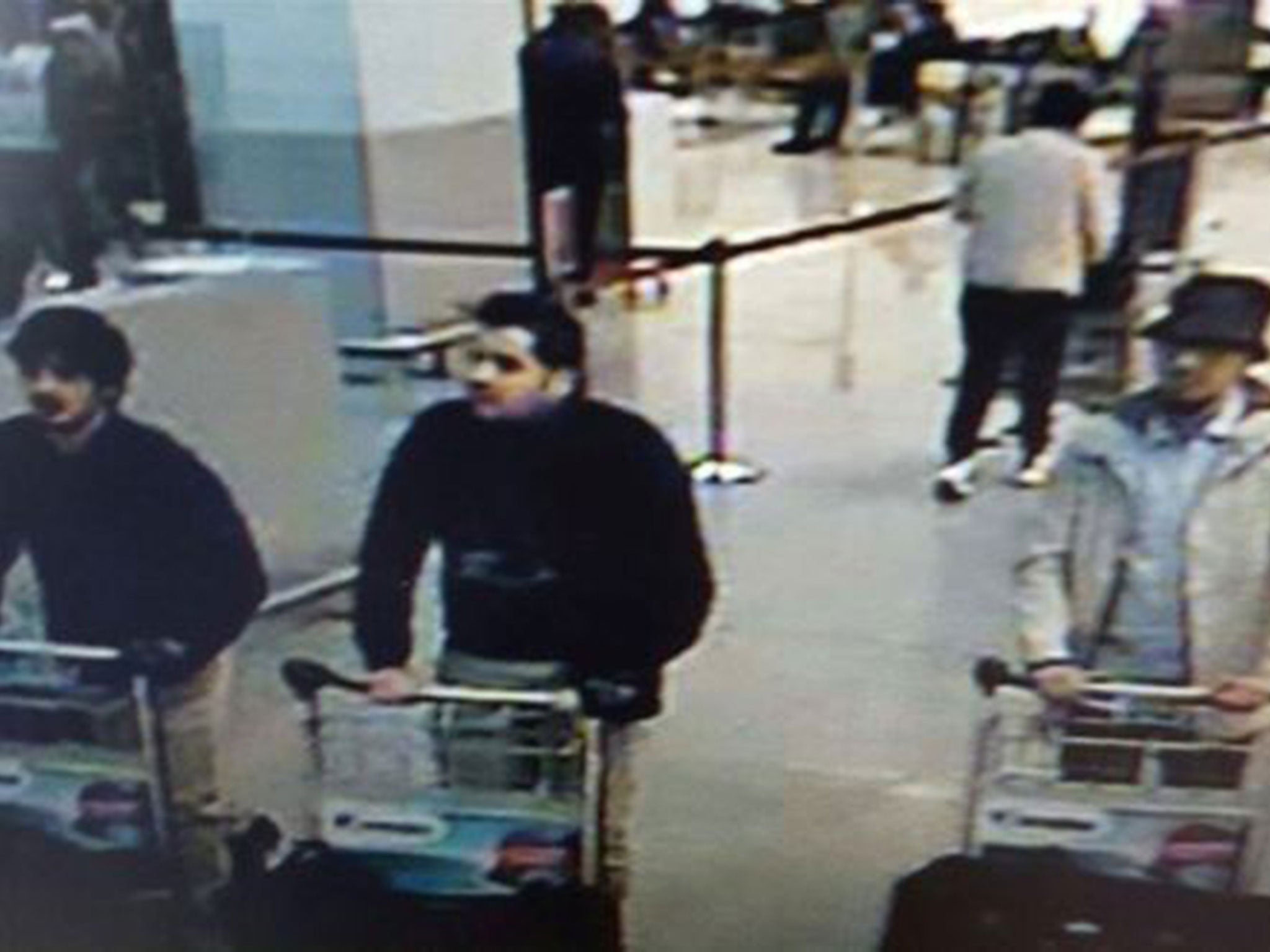 A picture released on March 22, 2016 by the belgian federal police on demand of the Federal prosecutor shows a screengrab of the airport CCTV camera showing three suspects of this morning's attacks at Brussels Airport, in Zaventem