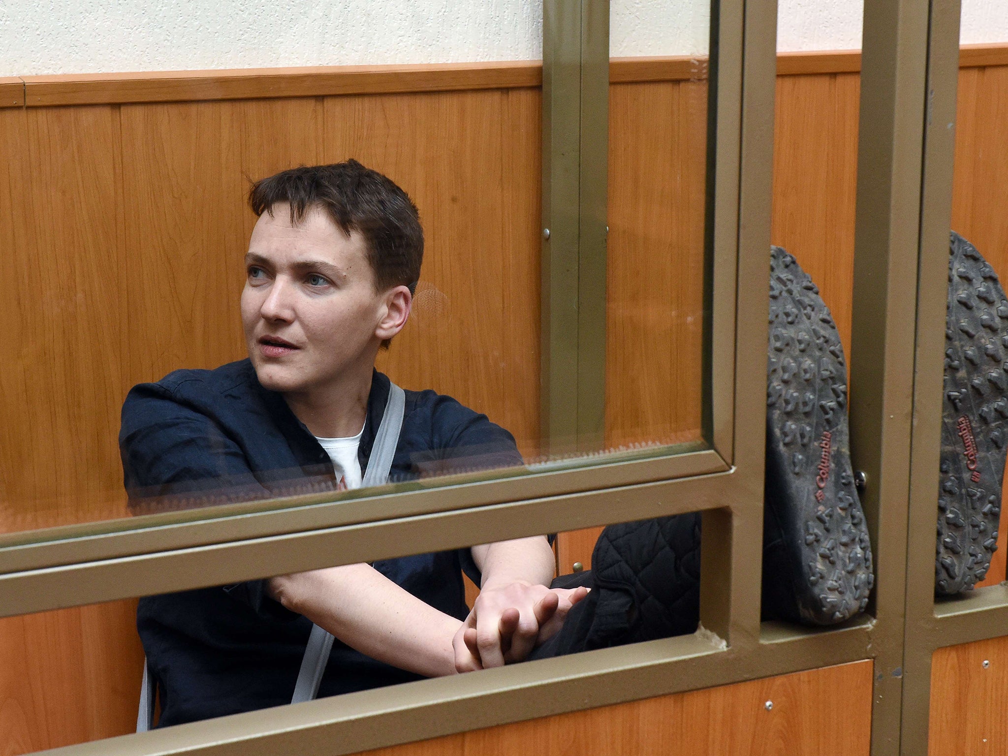 Ukrainian military pilot Nadiya Savchenko sits inside a defendant's cage during her sentencing hearing at a court in the southern Russian town of Donetsk