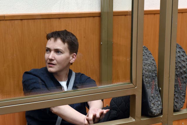 Ukrainian military pilot Nadiya Savchenko sits inside a defendant's cage during her sentencing hearing at a court in the southern Russian town of Donetsk