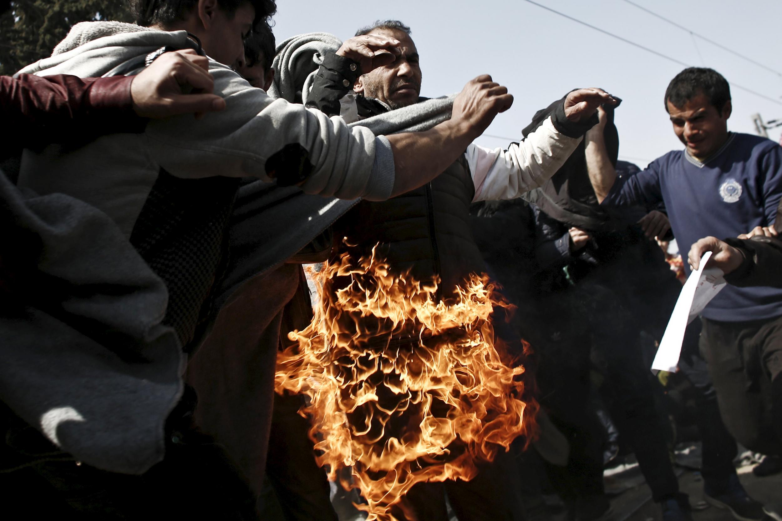 A refugee sets himself on fire during a protest by refugees and migrants demanding that the Greek-Macedonian border be opened,