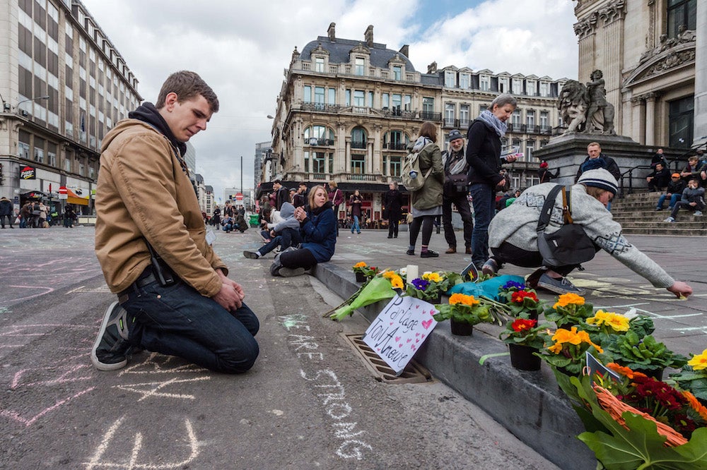 A man looks at memorials outside the stock exchange in Brussels on Tuesday.