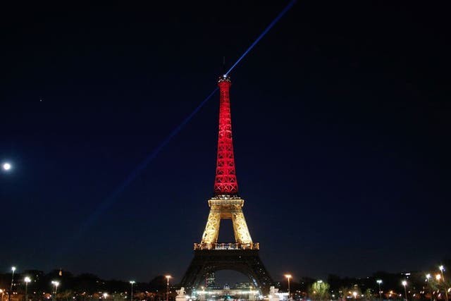 The Eiffel tower is lit up with the Belgian flag colours of red, yellow and black on March 22, 2016 in Paris, France