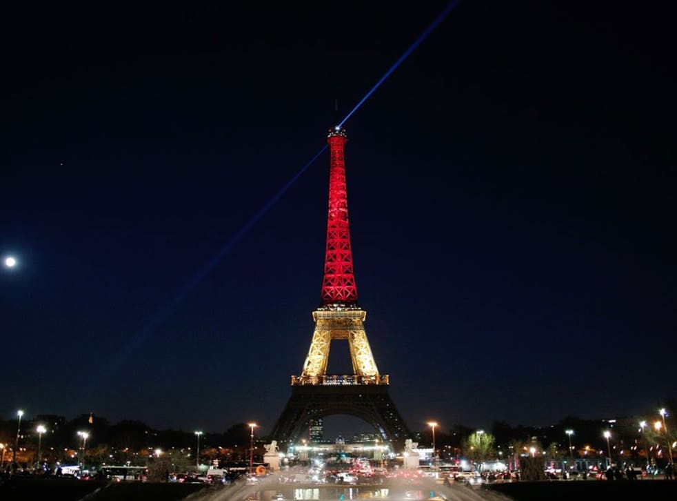 The Eiffel tower is lit up with the Belgian flag colours of red, yellow and black on March 22, 2016 in Paris, France