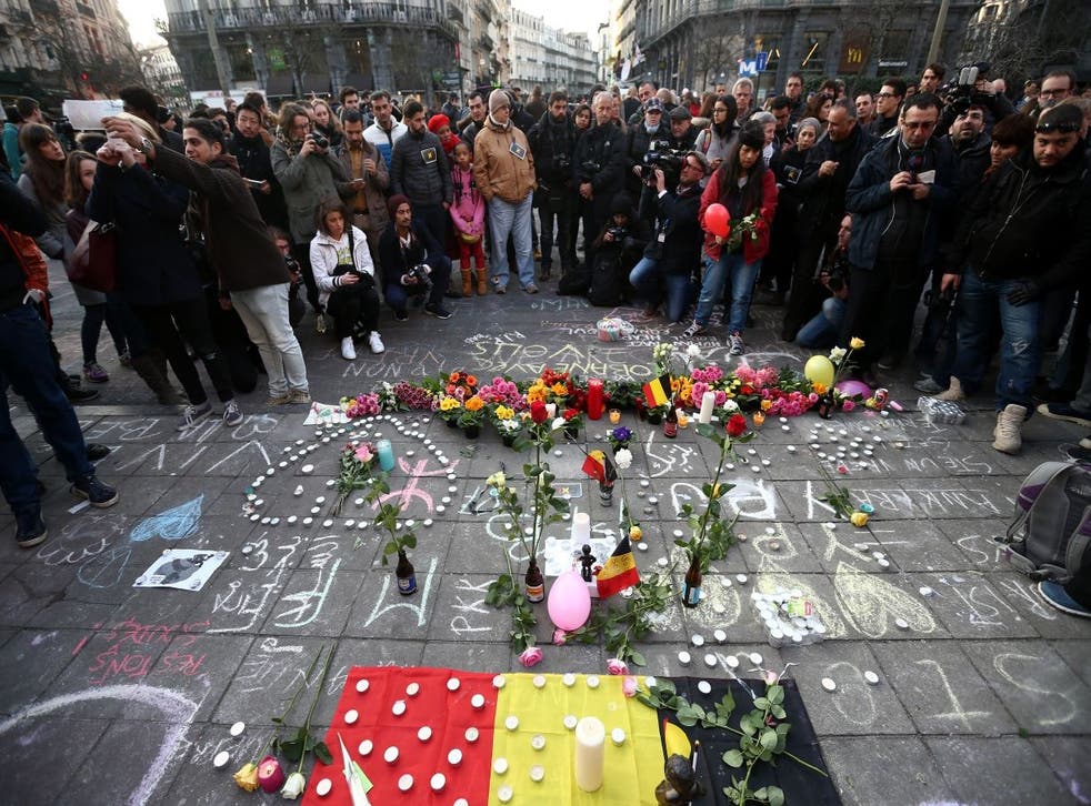 People gather to leave tributes at the Place de la Bourse following today's attacks on March 22, 2016 in Brussels, Belgium