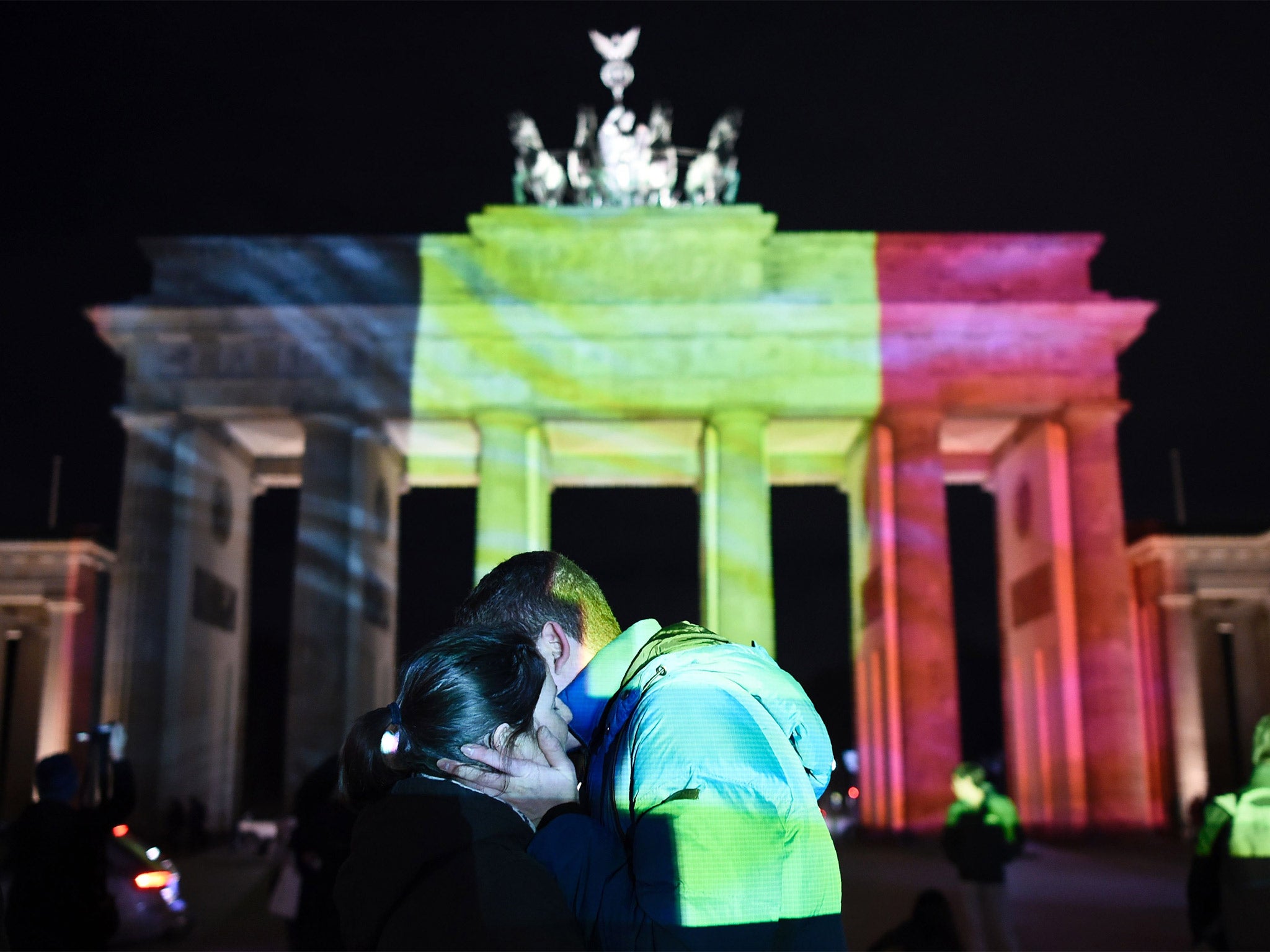 The colors of the Belgian flag are projected on to the Brandenburg Gate in Berlin as the German capital shows its solidarity following the Brussels attacks