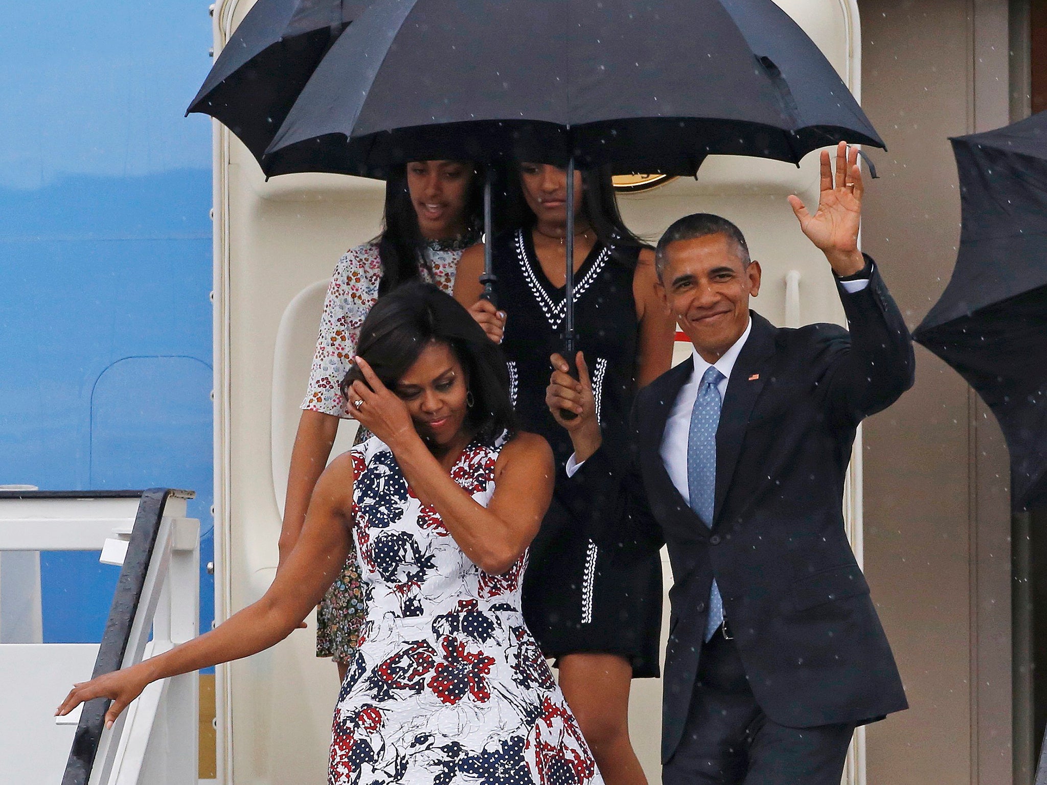 &#13;
President Obama, his wife Michelle, and their daughters Malia and Sasha, exit Air Force One as they arrive in Havana&#13;