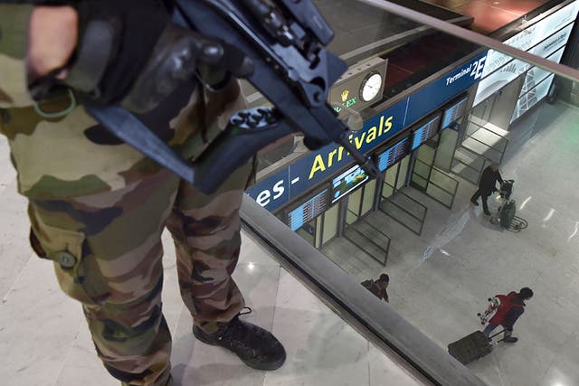 A soldier patrols inside the arrival terminal of the Charles de Gaulle Airport