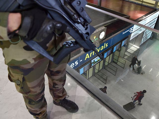 A soldier patrols inside the arrival terminal of the Charles de Gaulle Airport