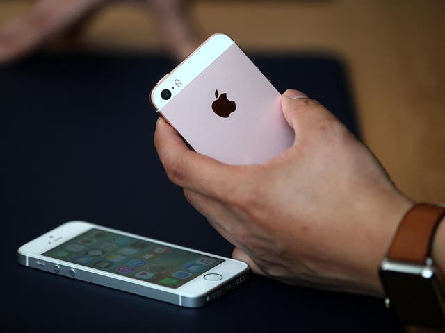 An attendee inspects the new iPhone SE during an Apple special event at the Apple headquarters on March 21, 2016 in Cupertino, California
