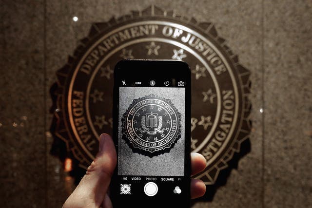 The FBI logo is seen through an iPhone camera at the bureau's headquarters in Washington, D.C