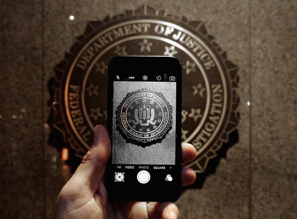 The FBI logo is seen through an iPhone camera at the bureau's headquarters in Washington, D.C