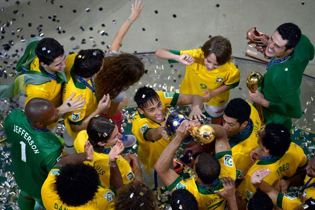 Neymar da Silva Santos, centre, and his Brazilian teammates celebrate winning the tournament in Rio in 2013