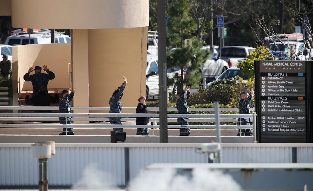 People evacuate the Naval Medical Center San Diego on January 26, 2016.