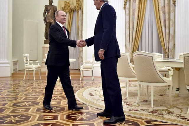 John Kerry shakes hands with Russian President Vladimir Putin during a meeting at the Kremlin in Moscow