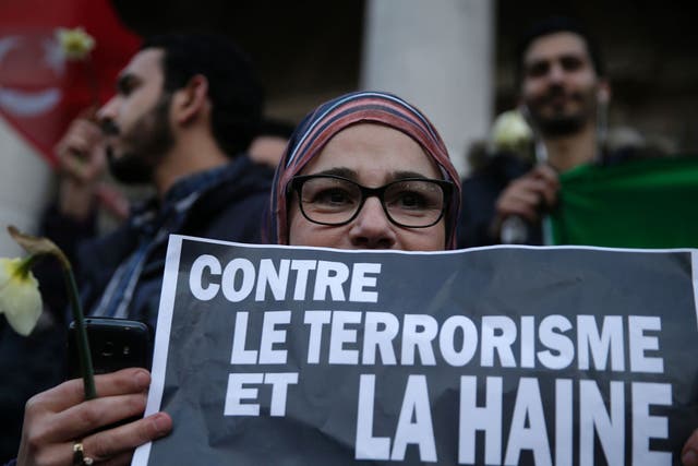 A woman holds a placard reading ‘Against terrorism and hatred, Solidarity’, at a makeshift memorial on the Place de la Bourse in Brussels. Responsibility for the attack has been claimed by Isis