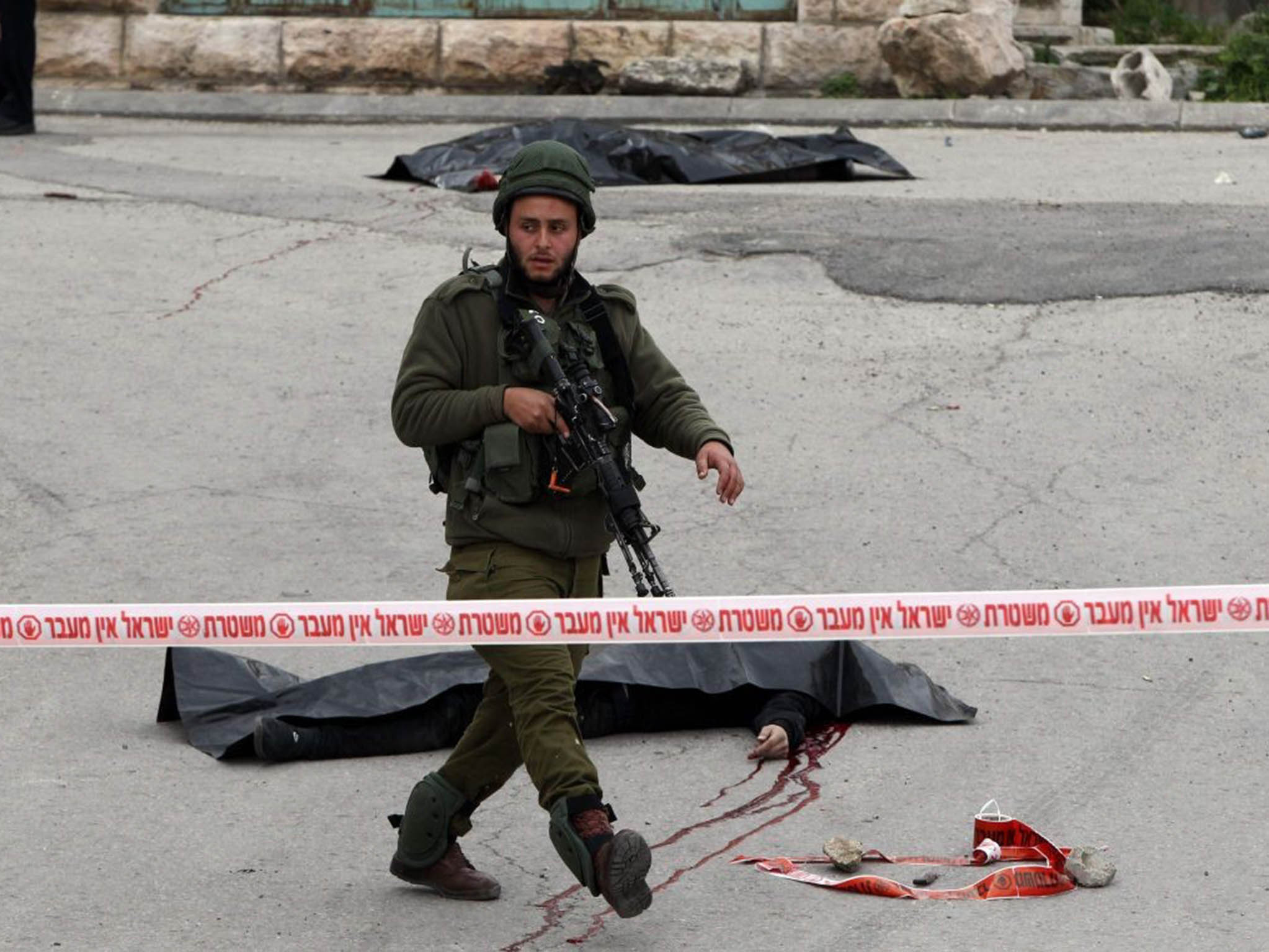 An Israeli soldier at the scene of two killings in Hebron