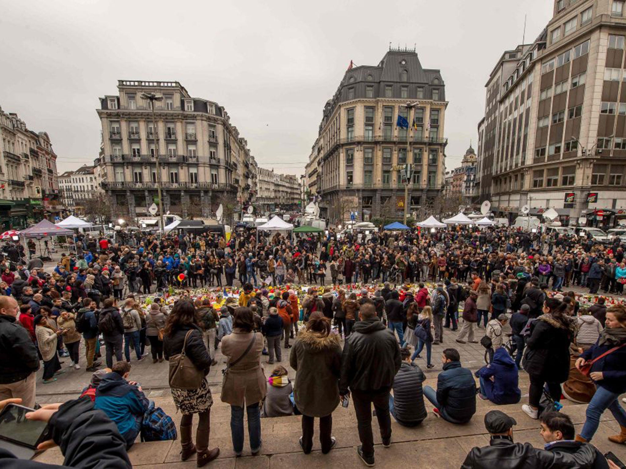 People gather at a makeshift memorial at Place de la Bourse as Prime Minister Charles Michel refused to accept the resignations of two of his staff