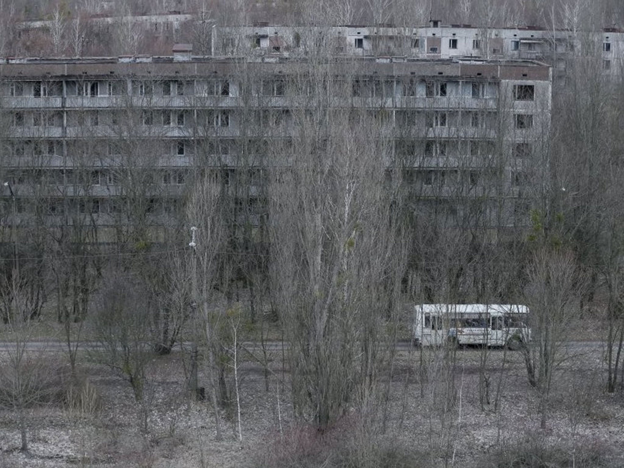 Employees ride a bus in the abandoned city of Pripyat