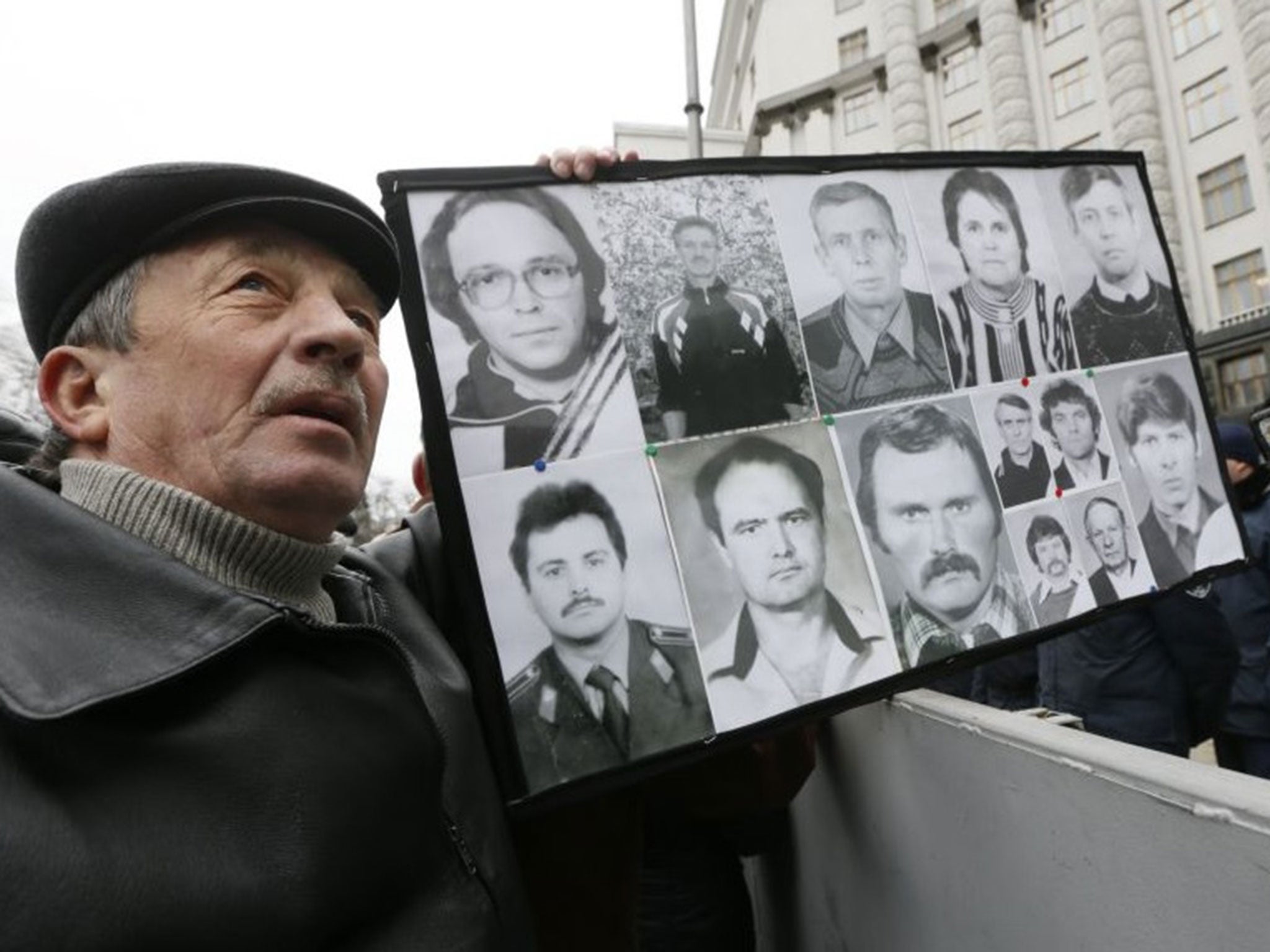 A protester carries a portrait of late liquidators and emergency workers at the same rally