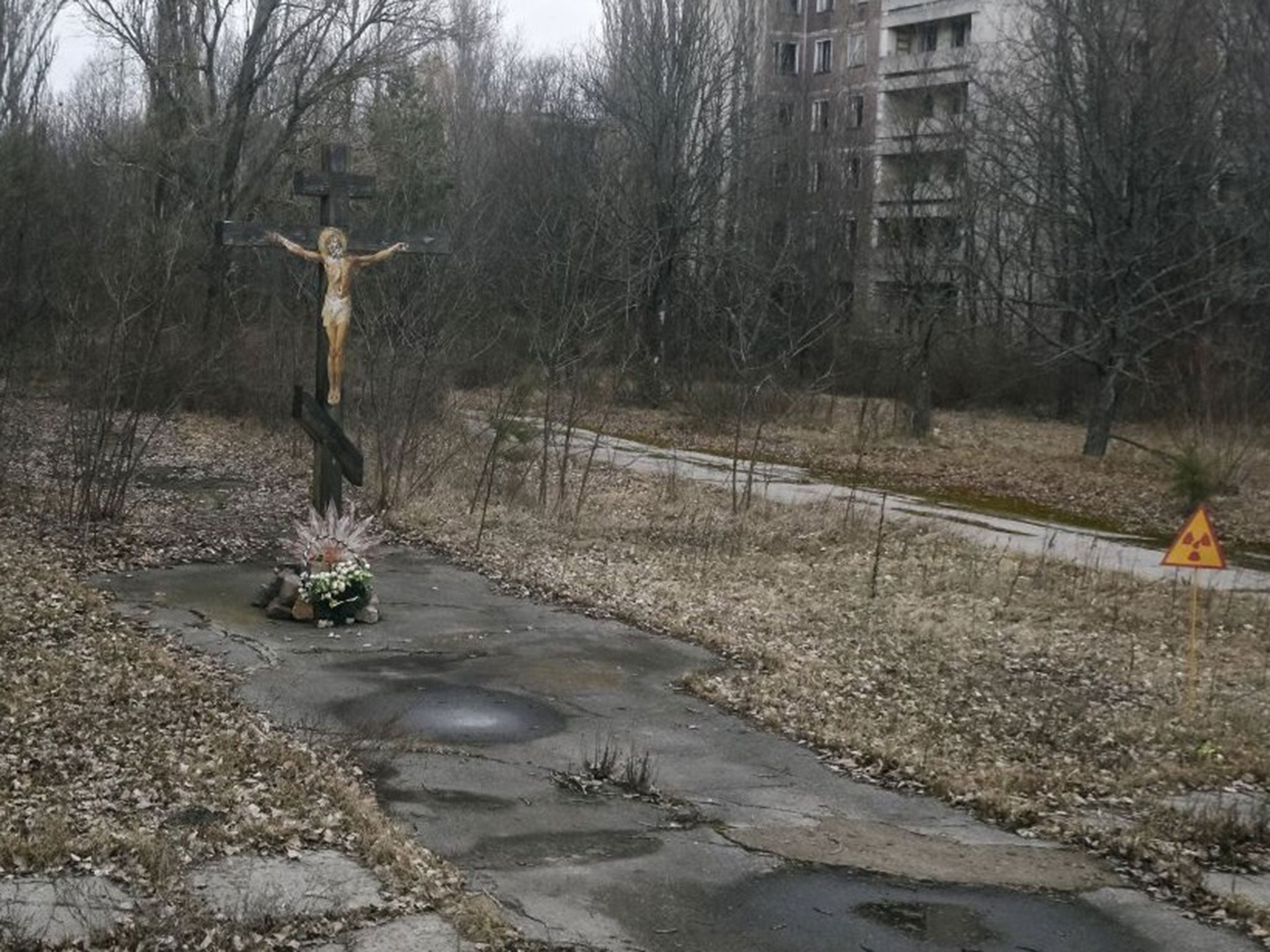 A cross with a crucifix is seen in the deserted Pripyat